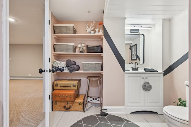 324 W Crystal Lake Ave, Crystal Lake, IL 60014 - interior space featuring a baseboard heating unit, toilet, vanity, and baseboards