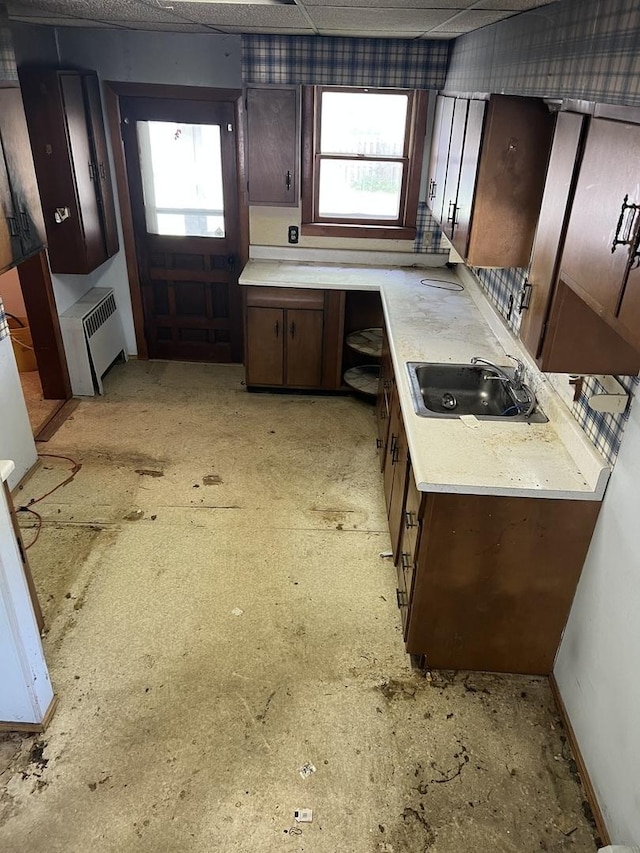 202 W Fourth St, Leaf River, IL 61047 - kitchen featuring a sink, light countertops, and dark brown cabinetry