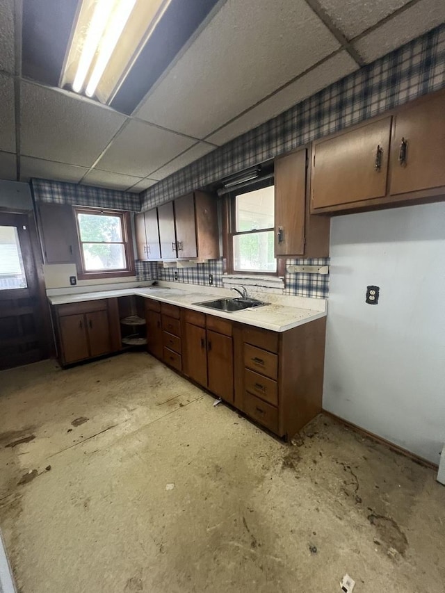 202 W Fourth St, Leaf River, IL 61047 - kitchen featuring a sink, a paneled ceiling, and light countertops