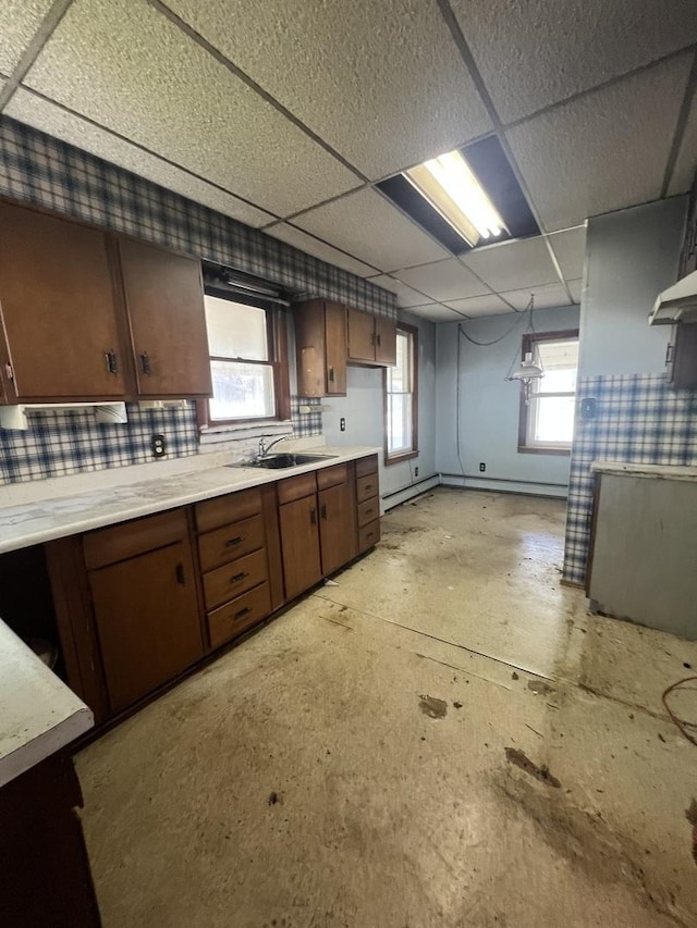 202 W Fourth St, Leaf River, IL 61047 - kitchen with a sink, light countertops, a drop ceiling, and baseboards