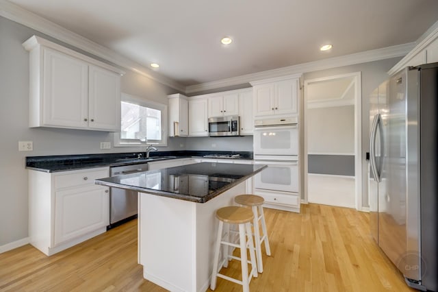 3744 Highknob Cir, Naperville, IL 60564 - kitchen featuring stainless steel appliances, white cabinets, crown molding, light wood-style flooring, and a breakfast bar area