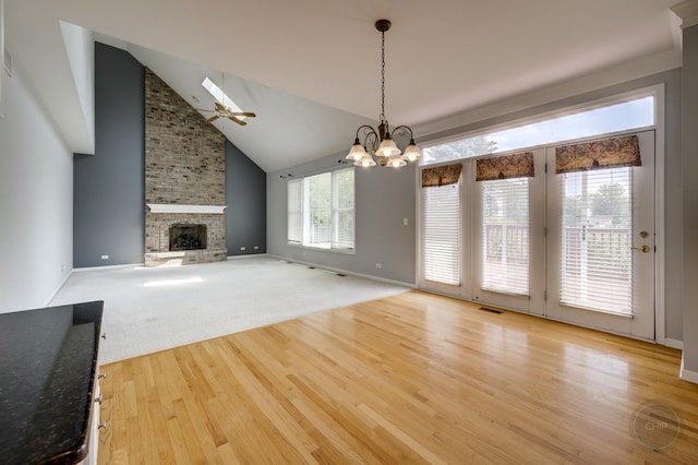 3744 Highknob Cir, Naperville, IL 60564 - unfurnished living room featuring light wood-style floors, a fireplace, a ceiling fan, a chandelier, and high vaulted ceiling