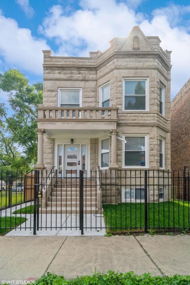 157 N Leamington Ave, Chicago, IL 60644 - view of front of house featuring a fenced front yard, stone siding, and a gate