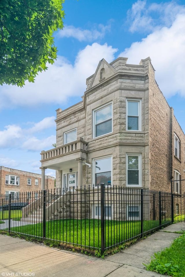 157 N Leamington Ave, Chicago, IL 60644 - view of front of house with stone siding and a fenced front yard