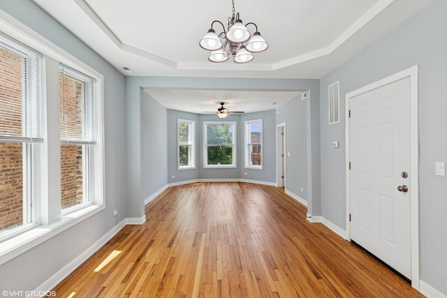 157 N Leamington Ave, Chicago, IL 60644 - unfurnished dining area featuring a chandelier, light wood-style floors, a raised ceiling, and a ceiling fan