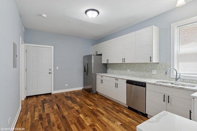 157 N Leamington Ave, Chicago, IL 60644 - kitchen featuring stainless steel appliances, dark wood-style flooring, decorative backsplash, light stone countertops, and electric panel