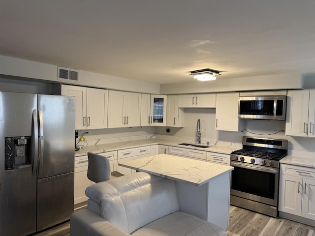 11540 S Racine Ave, Chicago, IL 60643 - kitchen with stainless steel appliances, a sink, white cabinets, and light stone counters