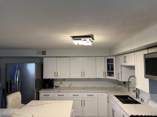 11540 S Racine Ave, Chicago, IL 60643 - kitchen featuring appliances with stainless steel finishes, a sink, white cabinetry, and light stone counters