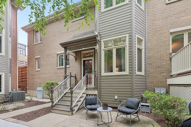 1248 W Fletcher St Unit C, Chicago, IL 60657 - entrance to property featuring cooling unit, a patio, and brick siding
