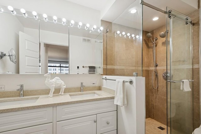 1430 N Astor St Unit 11C, Chicago, IL 60610 - bathroom featuring double vanity, a shower stall, and recessed lighting