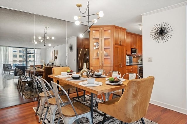 1430 N Astor St Unit 11C, Chicago, IL 60610 - dining space with a chandelier, dark wood-style floors, and baseboards