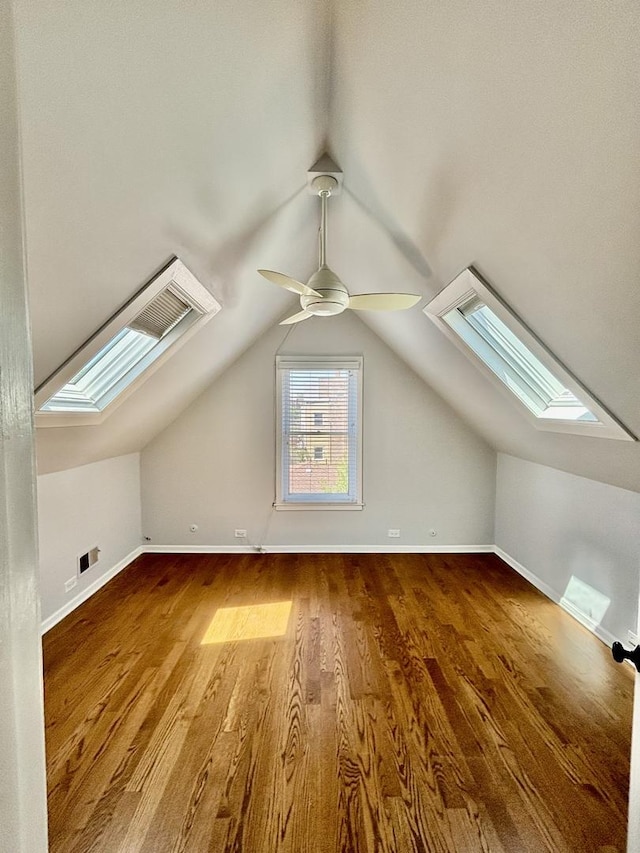 4118 N Kedzie Ave, Chicago, IL 60618 - additional living space featuring a skylight, a ceiling fan, vaulted ceiling, wood finished floors, and baseboards