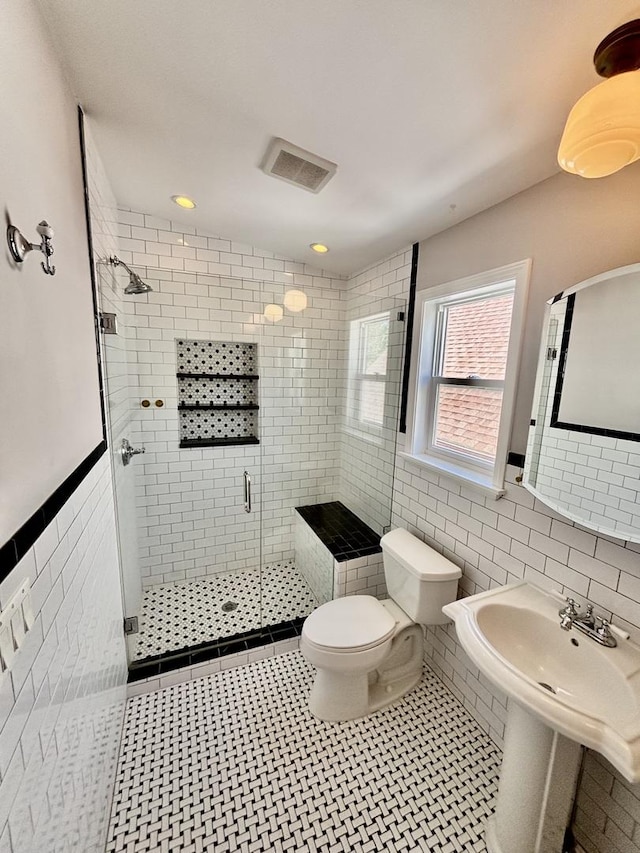 4118 N Kedzie Ave, Chicago, IL 60618 - full bath with tile walls, a shower stall, toilet, and wainscoting