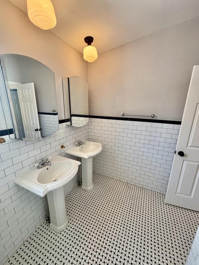 4118 N Kedzie Ave, Chicago, IL 60618 - bathroom with tile walls, a wainscoted wall, and a sink