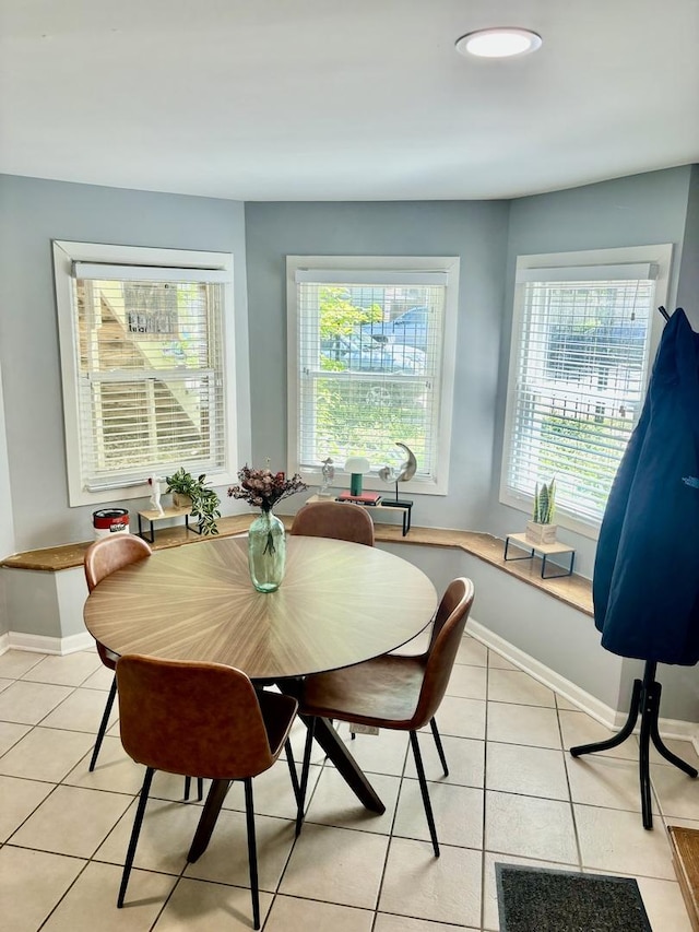 4118 N Kedzie Ave, Chicago, IL 60618 - dining area featuring plenty of natural light, light tile patterned floors, and baseboards