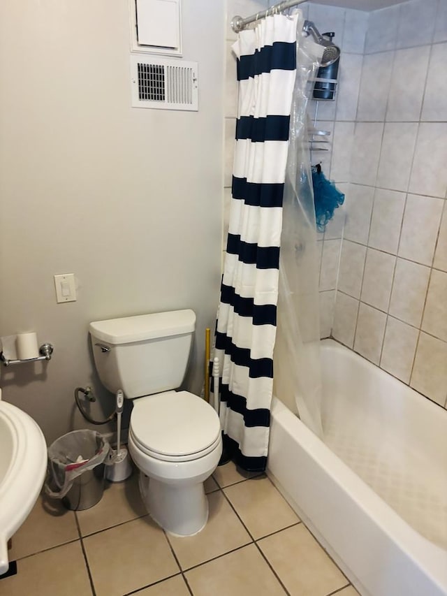 4118 N Kedzie Ave, Chicago, IL 60618 - bathroom featuring toilet, tile patterned flooring, and shower / bath combo