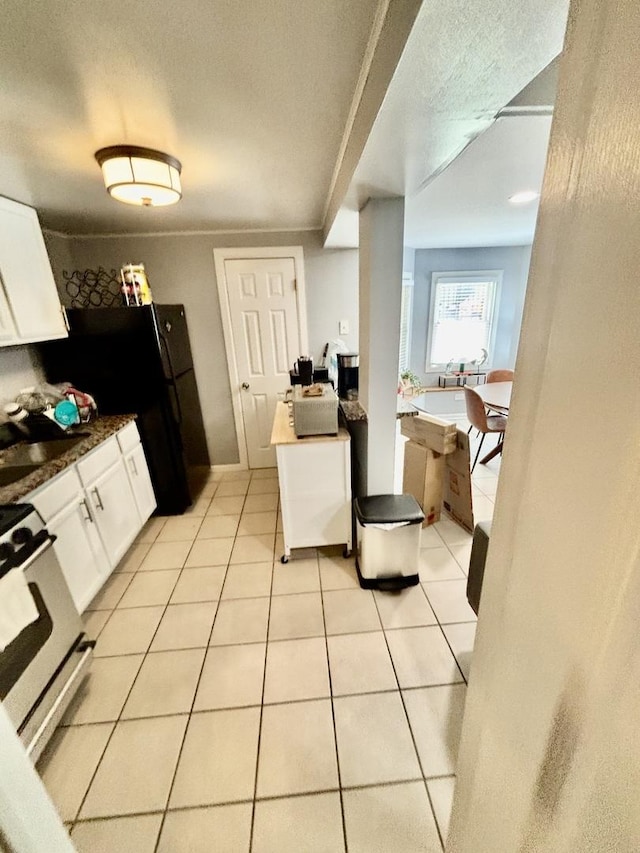 4118 N Kedzie Ave, Chicago, IL 60618 - kitchen with gas range, white cabinetry, light tile patterned floors, and a textured ceiling