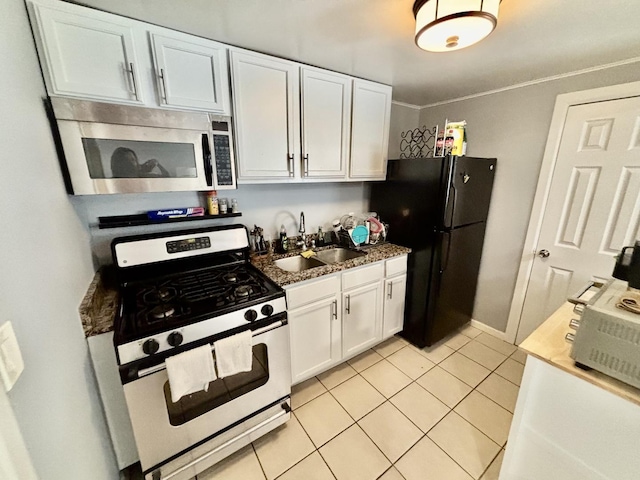 4118 N Kedzie Ave, Chicago, IL 60618 - kitchen with appliances with stainless steel finishes, a sink, white cabinetry, and light tile patterned floors