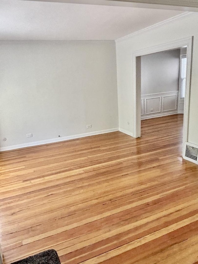 4118 N Kedzie Ave, Chicago, IL 60618 - spare room with light wood-style floors, crown molding, and baseboards