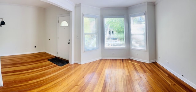 4118 N Kedzie Ave, Chicago, IL 60618 - entryway with light wood finished floors, arched walkways, ornamental molding, and baseboards