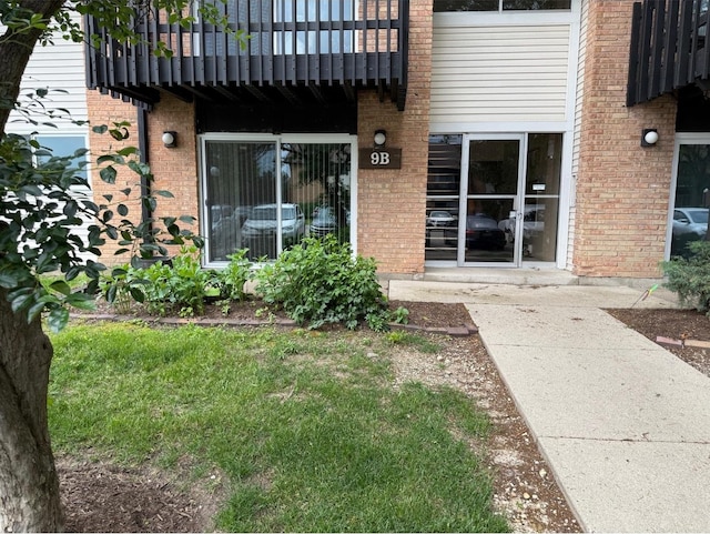 9B Kingery Quarter Unit 108, Willowbrook, IL 60527 - property entrance featuring brick siding and a balcony