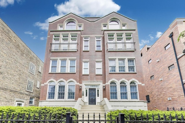 1952 W Fletcher St Unit 2W, Chicago, IL 60657 - view of front of house with brick siding and a fenced front yard
