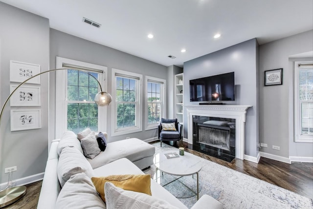 1952 W Fletcher St Unit 2W, Chicago, IL 60657 - living area featuring baseboards, dark wood-style flooring, a fireplace, recessed lighting, and built in features