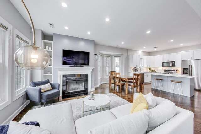 1952 W Fletcher St Unit 2W, Chicago, IL 60657 - living area with dark wood finished floors, a premium fireplace, baseboards, and recessed lighting