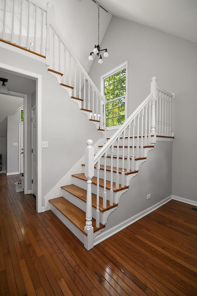 16864 E State Route 17, Grant Park, IL 60940 - stairs featuring a chandelier, high vaulted ceiling, wood-type flooring, and baseboards