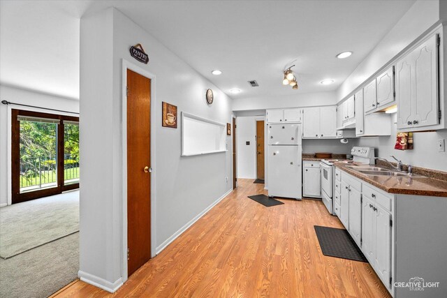 1120 N Farnsworth Ave Unit 2C, Aurora, IL 60505 - kitchen with white appliances, a sink, dark countertops, light wood finished floors, and recessed lighting