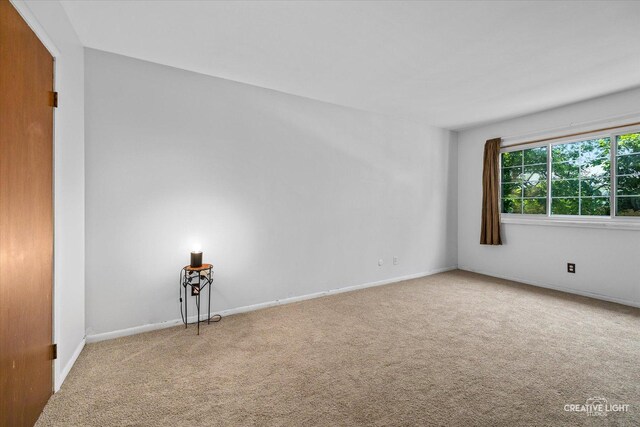 1120 N Farnsworth Ave Unit 2C, Aurora, IL 60505 - carpeted spare room with baseboards