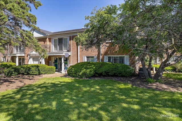 1120 N Farnsworth Ave Unit 2C, Aurora, IL 60505 - view of front of home featuring brick siding and a front yard