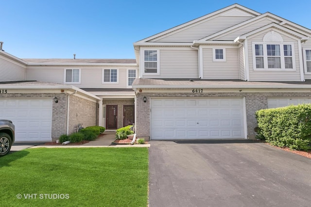 6417 Blue Sky Ln, Matteson, IL 60443 - view of property with driveway, brick siding, a front yard, and a garage