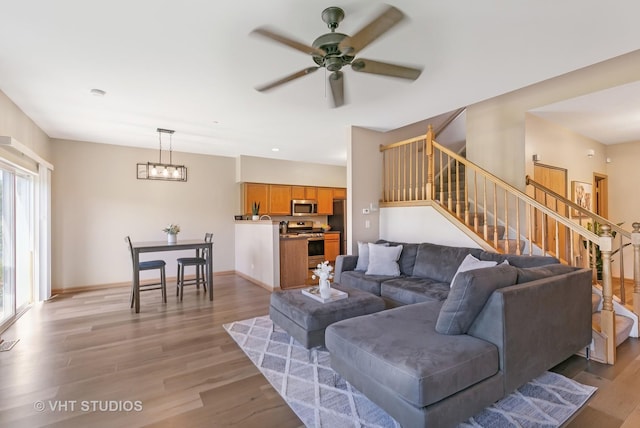 6417 Blue Sky Ln, Matteson, IL 60443 - living area featuring stairs, light wood-style flooring, a ceiling fan, and baseboards