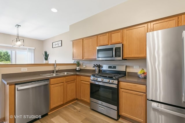 6417 Blue Sky Ln, Matteson, IL 60443 - kitchen with appliances with stainless steel finishes, a sink, a peninsula, dark countertops, and light wood-style flooring
