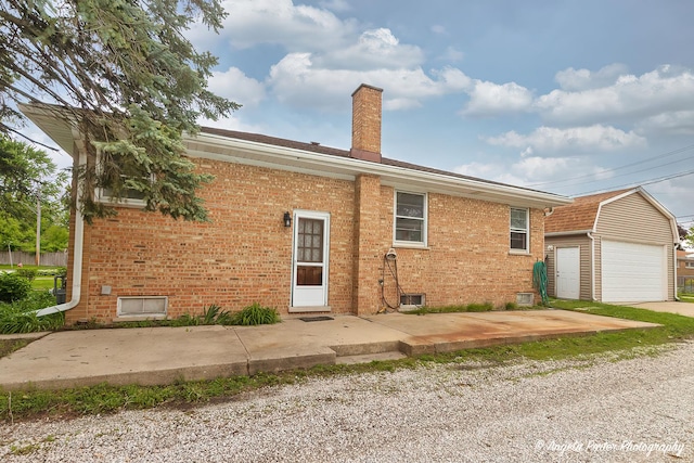 10067 Lavergne Ave, Skokie, IL 60077 - view of front of property featuring brick siding, a chimney, an outbuilding, and a detached garage