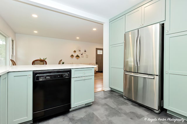 10067 Lavergne Ave, Skokie, IL 60077 - kitchen with freestanding refrigerator, black dishwasher, light countertops, recessed lighting, and a peninsula