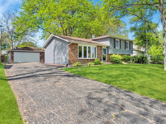 2109 Sprucewood Ln, Lindenhurst, IL 60046 - split level home with brick siding, a front yard, a detached garage, and an outbuilding