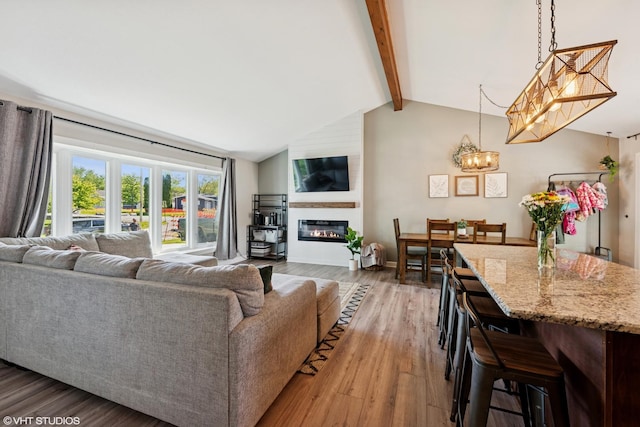2109 Sprucewood Ln, Lindenhurst, IL 60046 - living room featuring a chandelier, wood finished floors, and a large fireplace