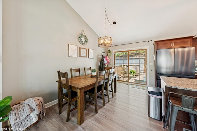 2109 Sprucewood Ln, Lindenhurst, IL 60046 - dining space featuring light wood-type flooring, a chandelier, and high vaulted ceiling