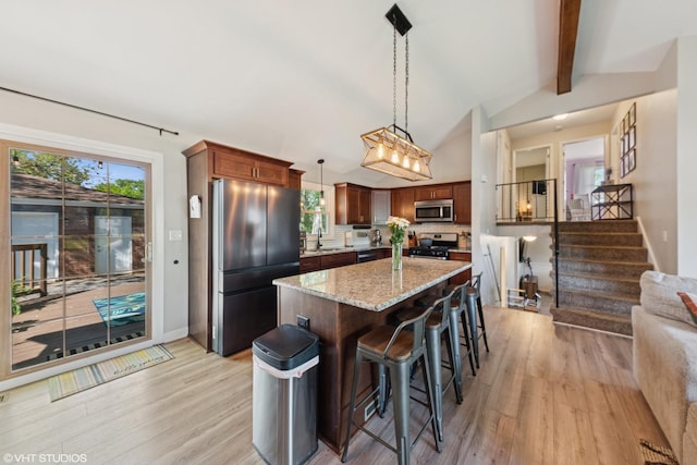 2109 Sprucewood Ln, Lindenhurst, IL 60046 - kitchen featuring stainless steel appliances, a sink, light wood finished floors, backsplash, and light stone counters