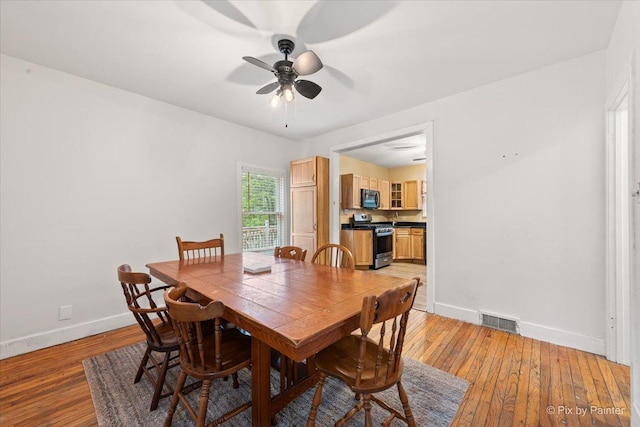 119 W S Ave, Spring Grove, IL 60081 - dining area featuring baseboards, a ceiling fan, and light wood finished floors