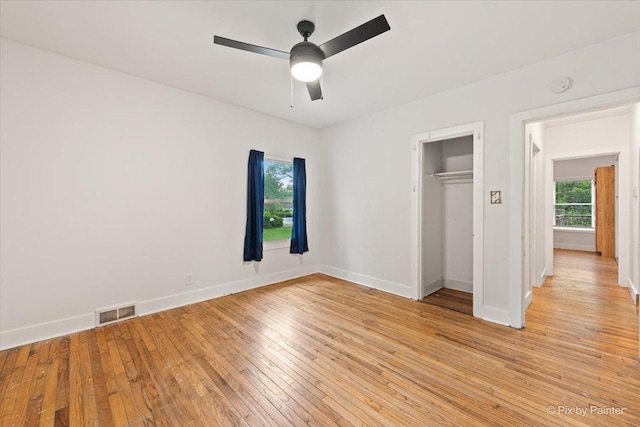 119 W S Ave, Spring Grove, IL 60081 - unfurnished bedroom featuring light wood-type flooring, baseboards, a closet, and ceiling fan