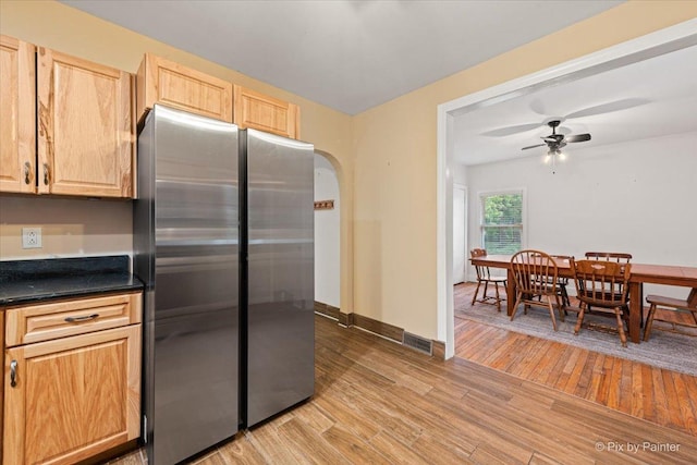 119 W S Ave, Spring Grove, IL 60081 - kitchen with freestanding refrigerator, light wood-style floors, arched walkways, and ceiling fan