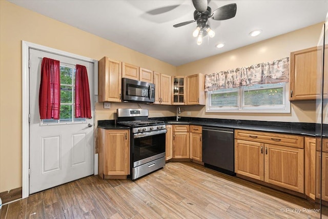 119 W S Ave, Spring Grove, IL 60081 - kitchen with appliances with stainless steel finishes, a sink, dark countertops, light wood-style floors, and recessed lighting