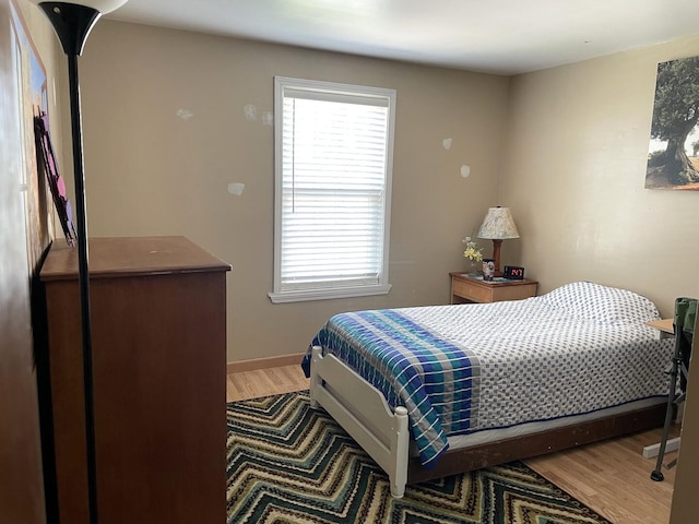 30W071 Kensington Dr, Warrenville, IL 60555 - bedroom featuring multiple windows, light wood-style flooring, and baseboards