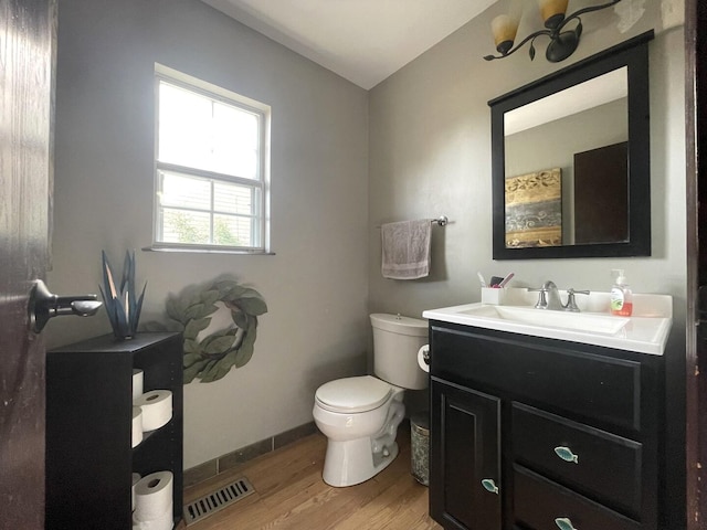 30W071 Kensington Dr, Warrenville, IL 60555 - full bathroom with wood finished floors, toilet, vanity, and baseboards