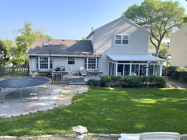 30W071 Kensington Dr, Warrenville, IL 60555 - back of house featuring a trampoline, a sunroom, a deck, roof with shingles, and a chimney