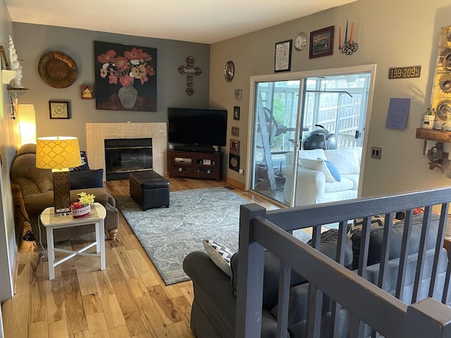 30W071 Kensington Dr, Warrenville, IL 60555 - living room featuring light wood-style flooring and a tiled fireplace