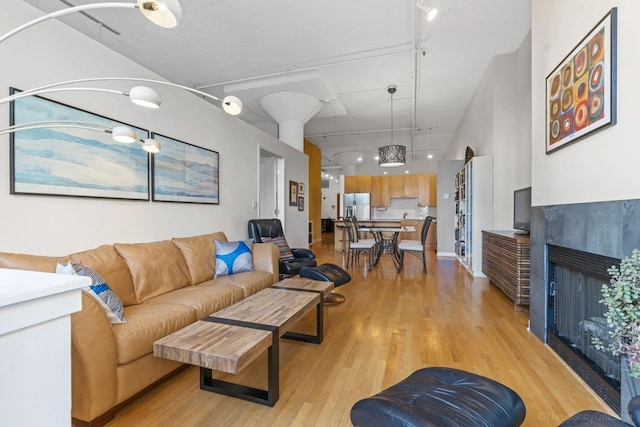 547 S Clark St Unit 704, Chicago, IL 60605 - living area with track lighting, light wood-type flooring, and a tile fireplace